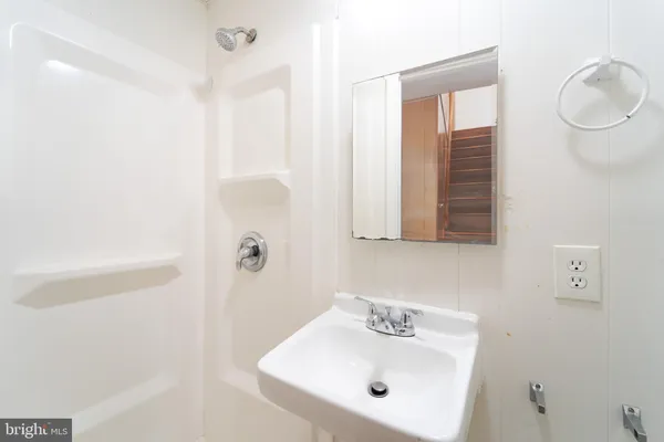 a view of a room with wooden floor and white walls