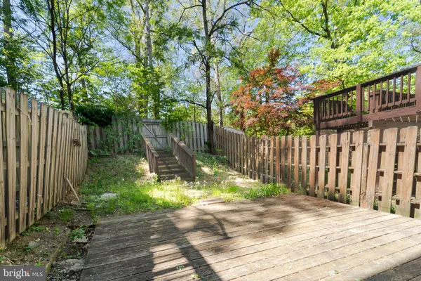 a view of a house with wooden fence