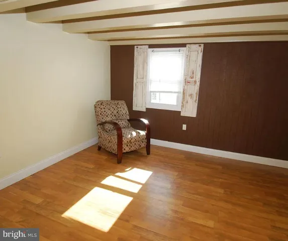 a view of a room with wooden floor and chair