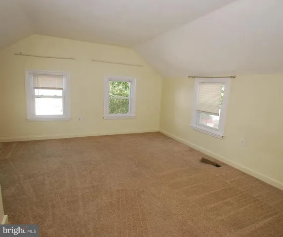 an empty room with a empty space and windows