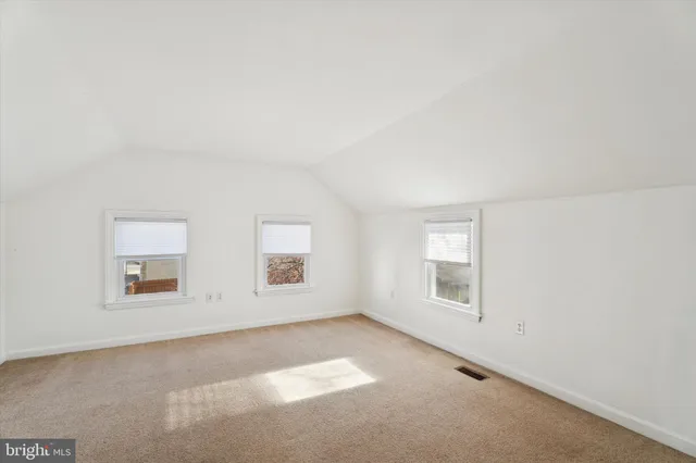 a view of an empty room and a window