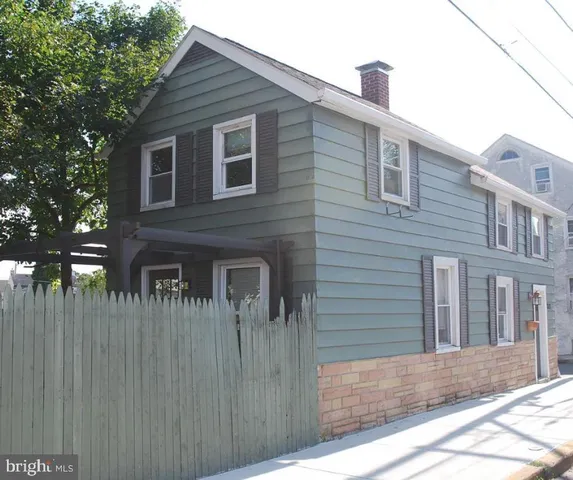 a view of a brick house with many windows