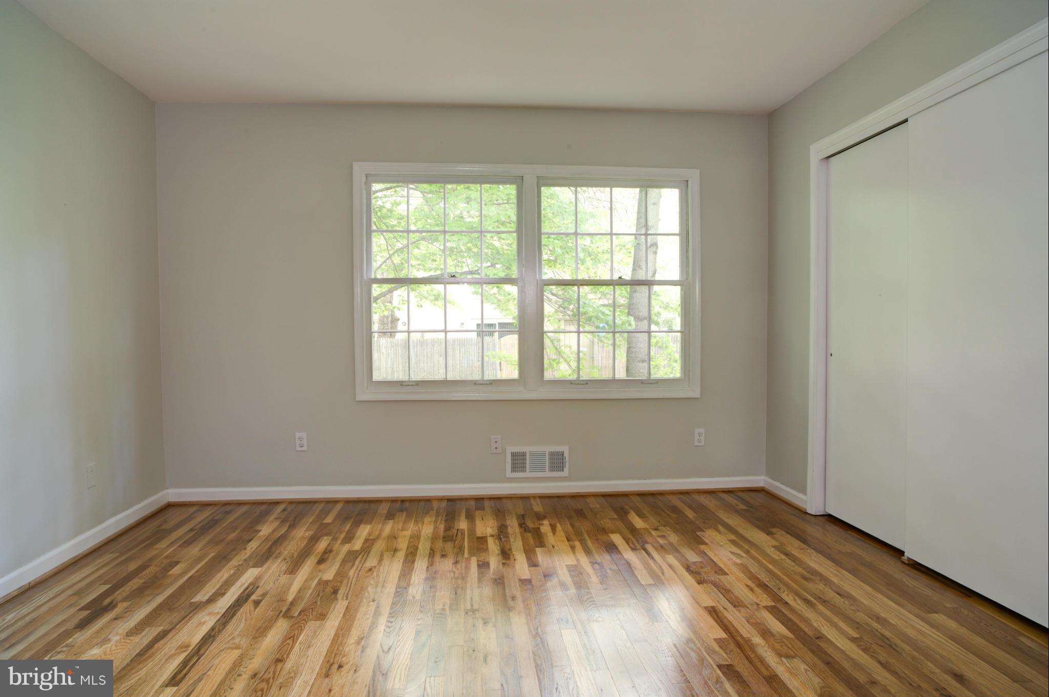 8129 Kingsway Court, Unit 283 Springfield, VA 22152 - Photo 15 of 22 wooden floor in an empty room with a window