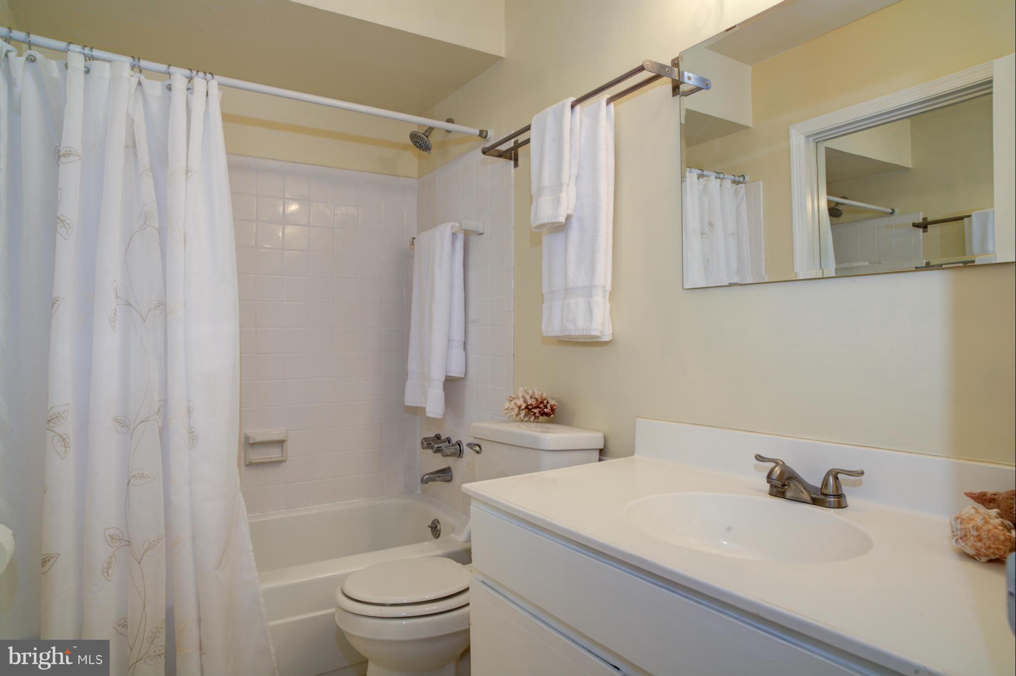 8129 Kingsway Court, Unit 283 Springfield, VA 22152 - Photo 16 of 22 a bathroom with a sink a toilet and a mirror