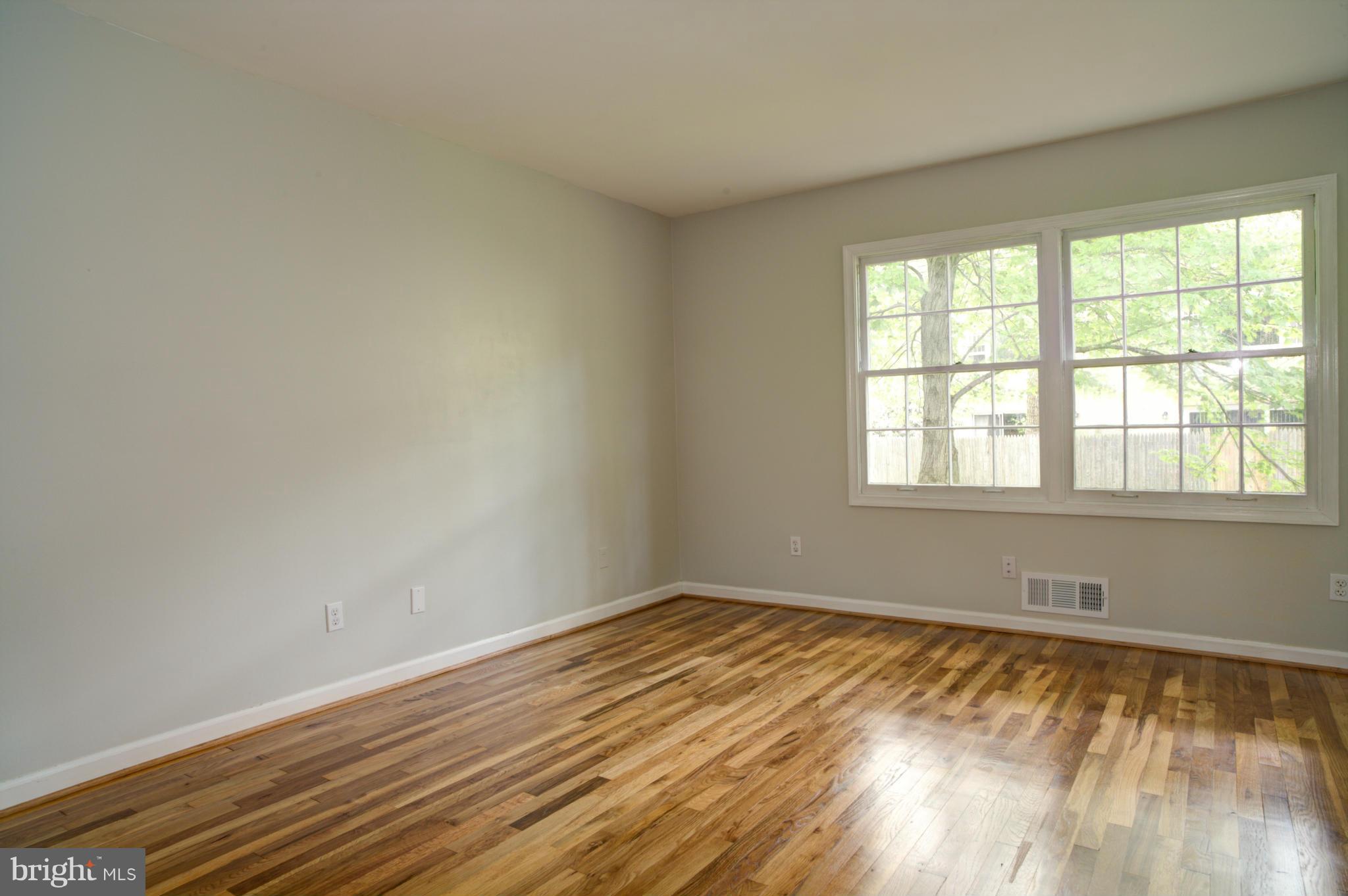8129 Kingsway Court, Unit 283 Springfield, VA 22152 - Photo 17 of 22 wooden floor in an empty room with a window