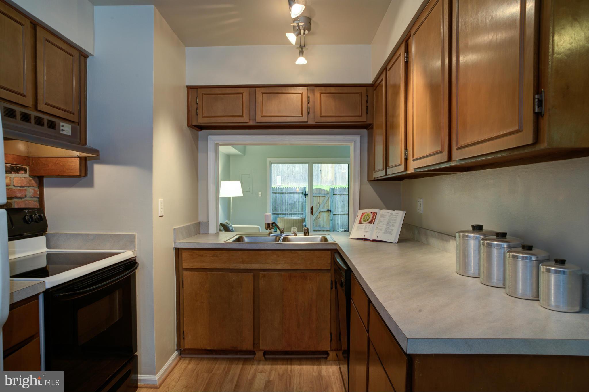 8129 Kingsway Court, Unit 283 Springfield, VA 22152 - Photo 6 of 22 a kitchen with a sink stove and cabinets