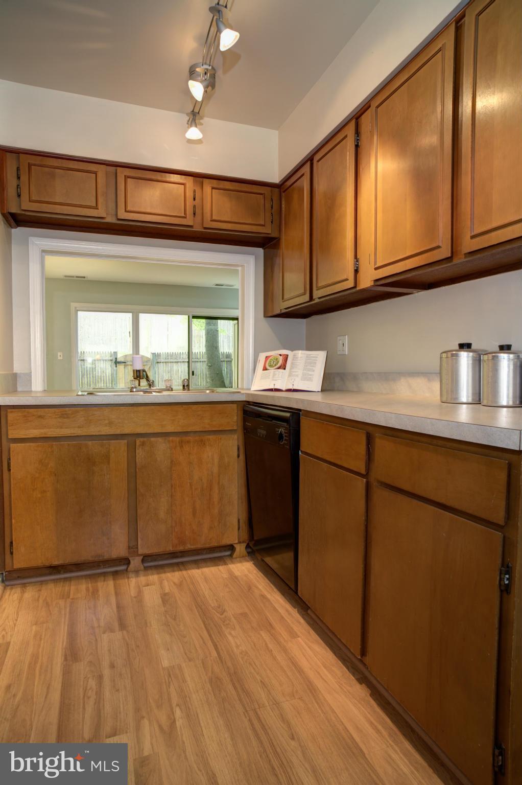 8129 Kingsway Court, Unit 283 Springfield, VA 22152 - Photo 7 of 22 a kitchen with stainless steel appliances granite countertop a sink a stove cabinets and wooden floor