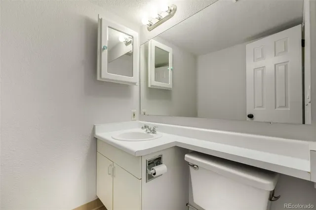 an empty room with closet and windows