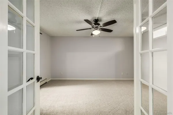 an empty room with closet and windows