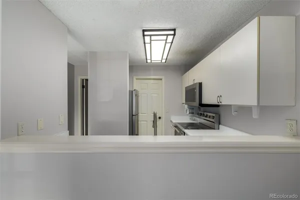 a kitchen with a sink and a refrigerator