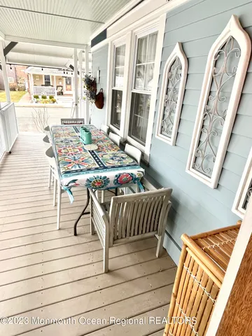 a view of a room with furniture and wooden floor