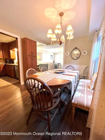 a view of a dining room with furniture and a chandelier