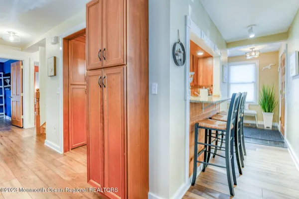 a view of a hallway with wooden floor and furniture