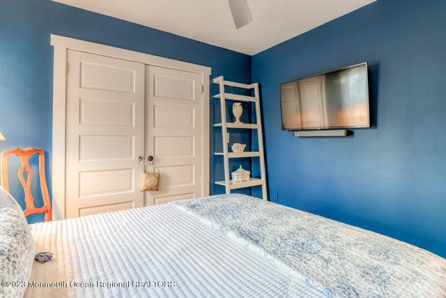 a bed room with a bed and a chair