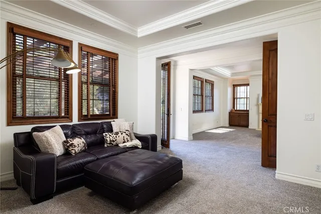 a room with two chair and large windows