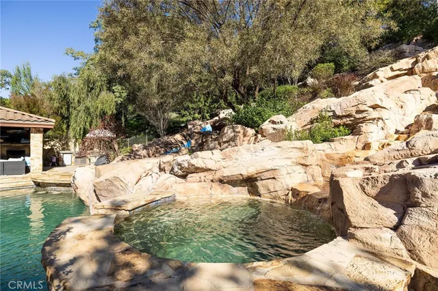 a view of a house with brick walls and a tree