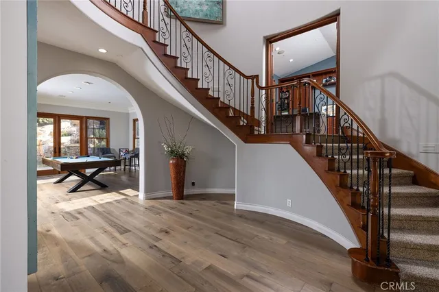a view of entryway and hall with wooden floor
