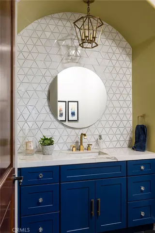 a kitchen with stainless steel appliances granite countertop a stove top oven a refrigerator a sink and chairs