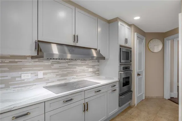 a kitchen with stainless steel appliances white cabinets and a sink