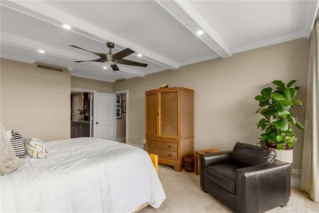 a bedroom with a large window and a bed