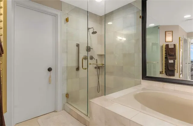 a en suite bathroom with a granite countertop double vanity and a mirror