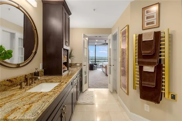 a living room with furniture a bookshelf and a large window