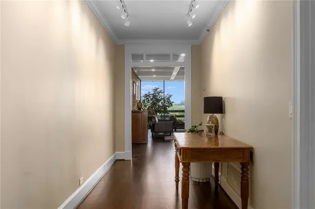 a hallway with a computer on a desk and chair