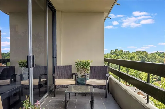 a balcony with furniture and a potted plant