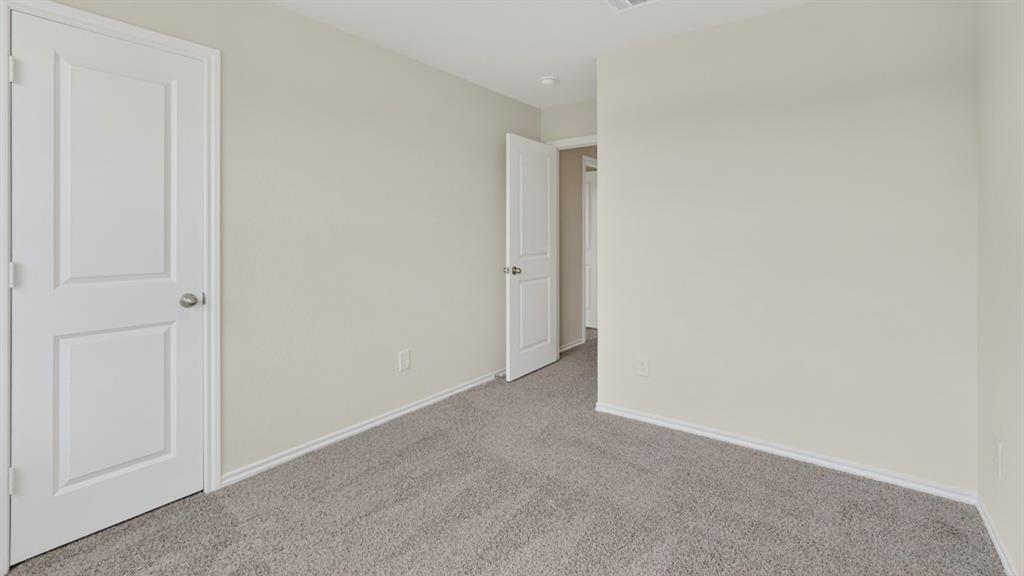 1683 Mantle Road Crandall, TX 75114 - Photo 26 of 31 Neutral-toned interior room with gray carpeting and light-colored walls