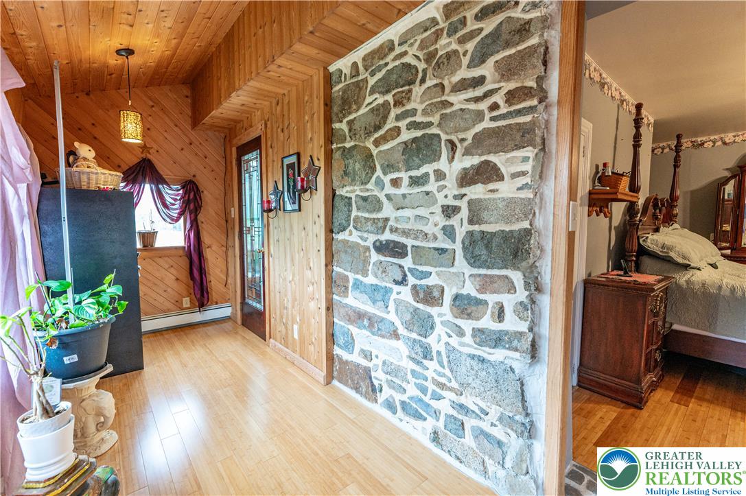 2485 Hieter Road Quakertown, PA 18951 - Photo 34 of 97 Natural wood paneling and stone accents create a rustic, welcoming interior hallway.
