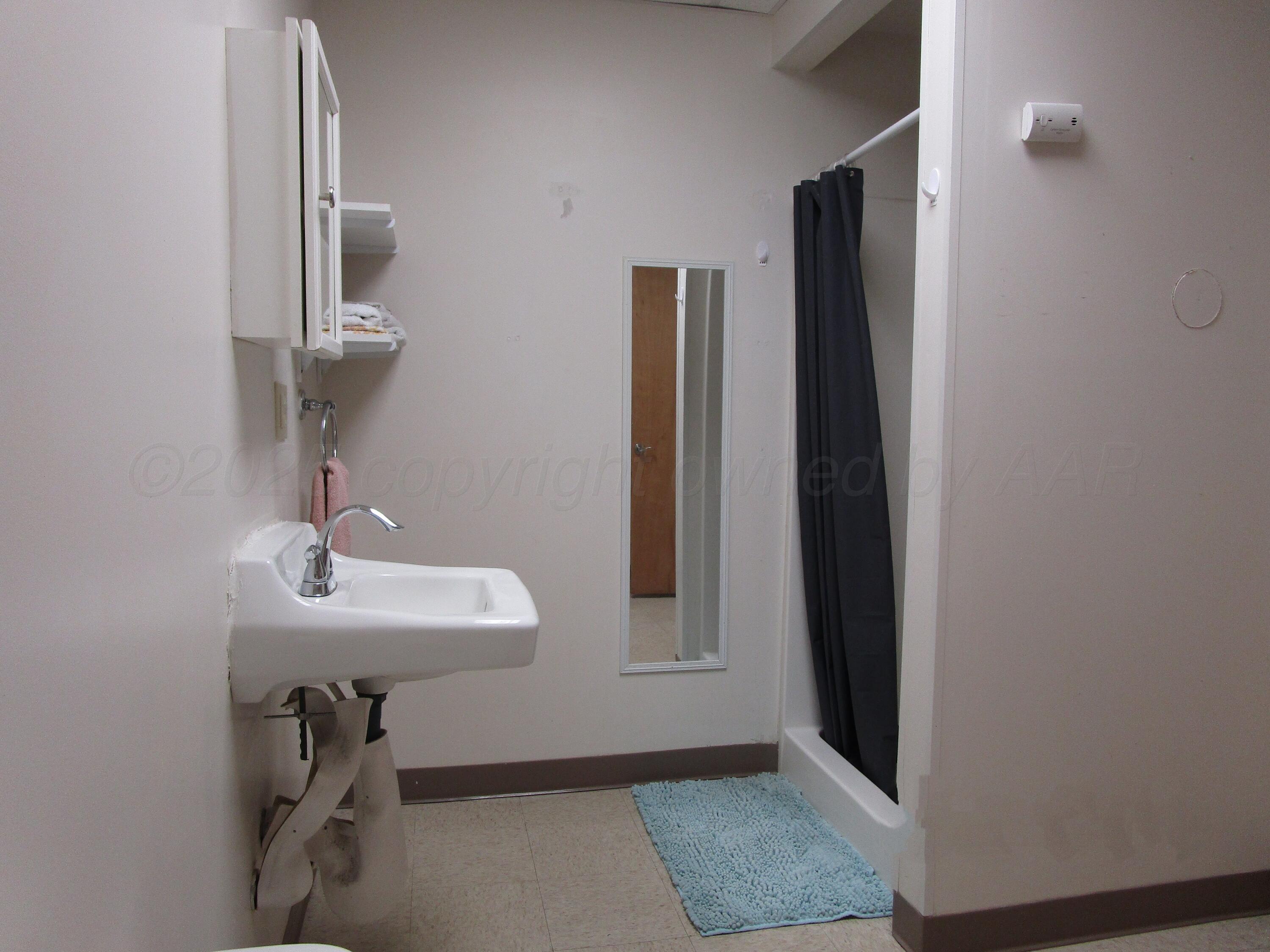 704 Deahl Street Borger, TX 79007 - Photo 8 of 8 a bathroom with a sink and a mirror