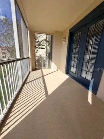 a view of a balcony with wooden floor and door