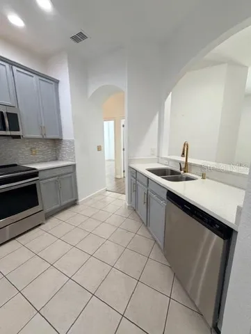 a kitchen with a sink cabinets and stainless steel appliances