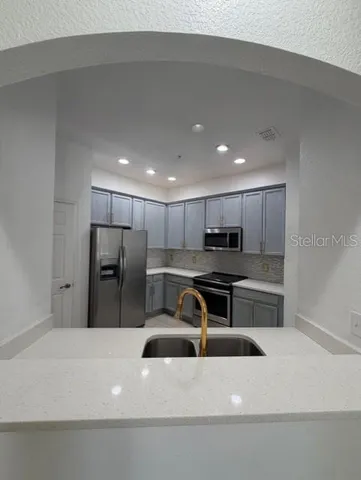 a kitchen with a refrigerator a stove and a sink