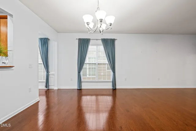 a view of a room with wooden floor