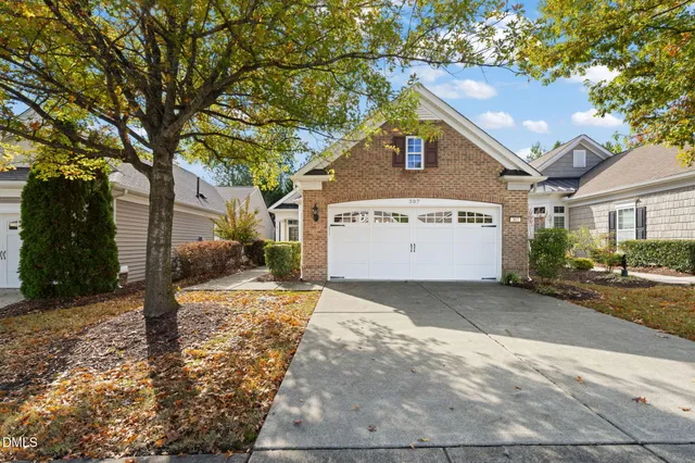 a view of a house with a yard and tree