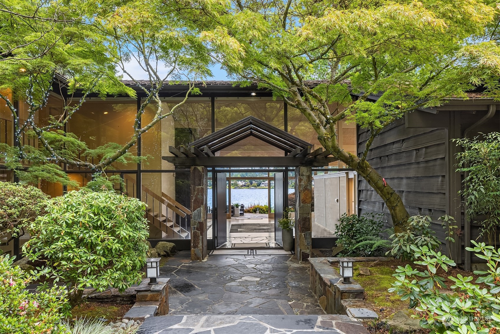 4232 Hunts Point Road Hunts Point, WA 98004 - Photo 2 of 23 a front view of a house with a garden