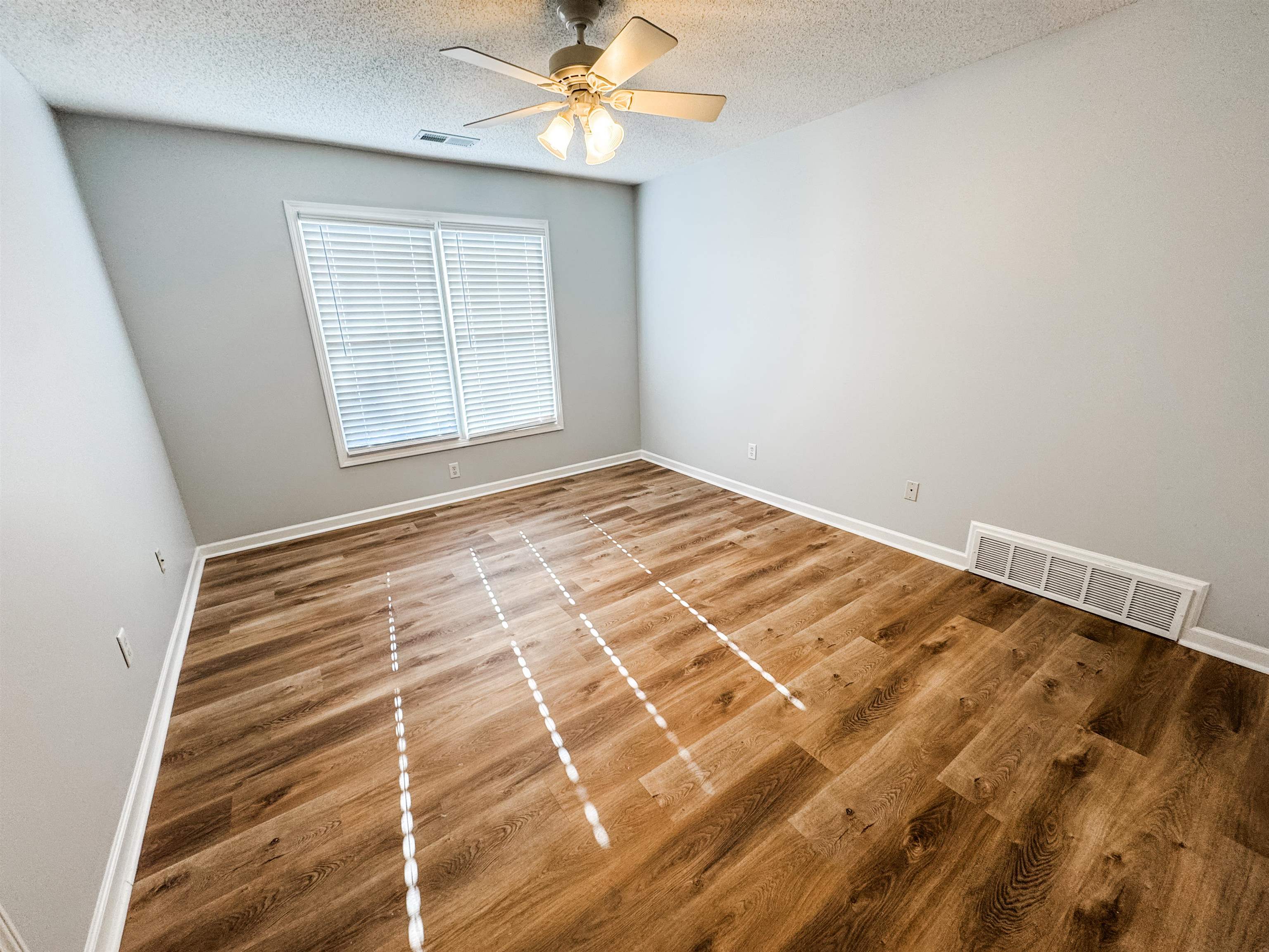 472 Hunters Mill Cove Collierville, TN 38017 - Photo 11 of 15 a view of a room with wooden floor and fan