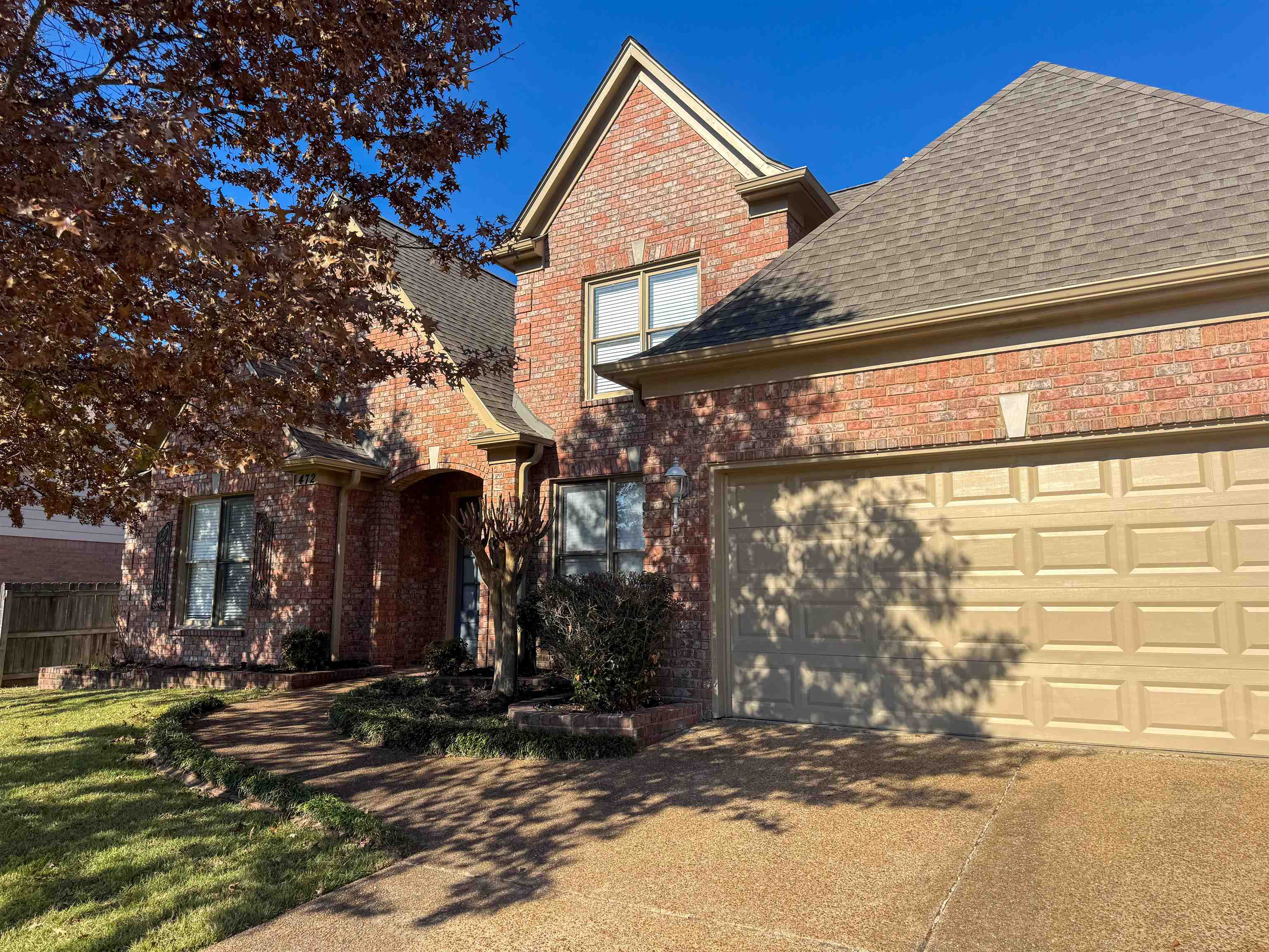 472 Hunters Mill Cove Collierville, TN 38017 - Photo 16 of 16 Traditional-style home featuring brick siding, driveway, roof with shingles, and a garage