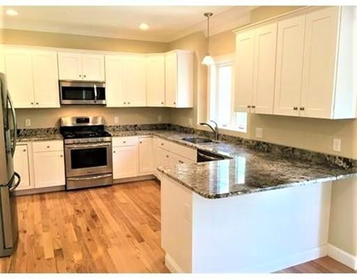 93 Clement Road Dracut, MA 01826 - Photo 10 of 25 a kitchen with stainless steel appliances granite countertop a stove a sink and a microwave