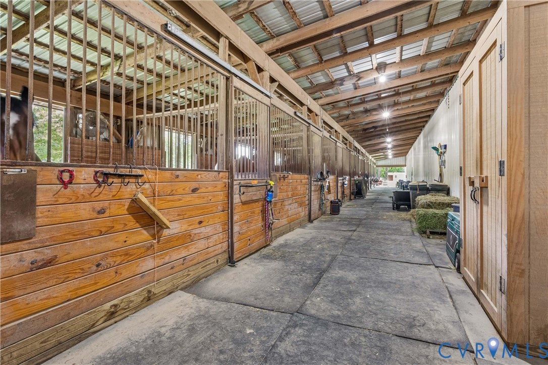 2016 Forge Road Toano, VA 23168 - Photo 18 of 99 Well-lit stable aisle featuring multiple stalls wi