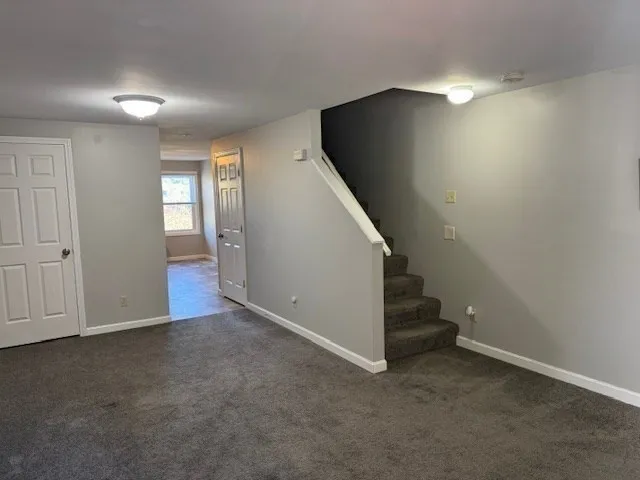 an empty room with windows and entrance