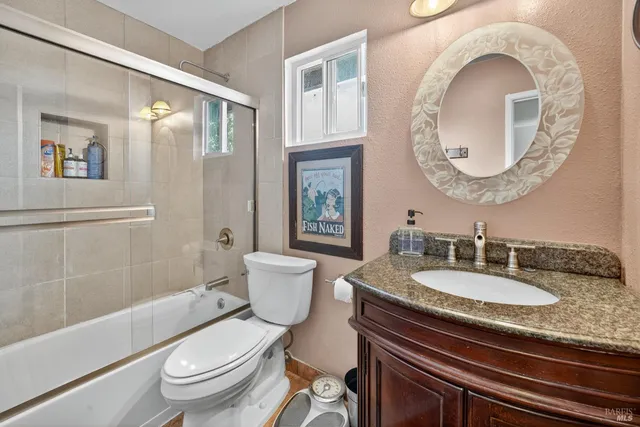 a bedroom with a bed window and couch