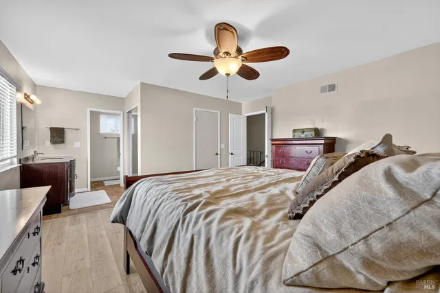 a view of a house with a yard and potted plants