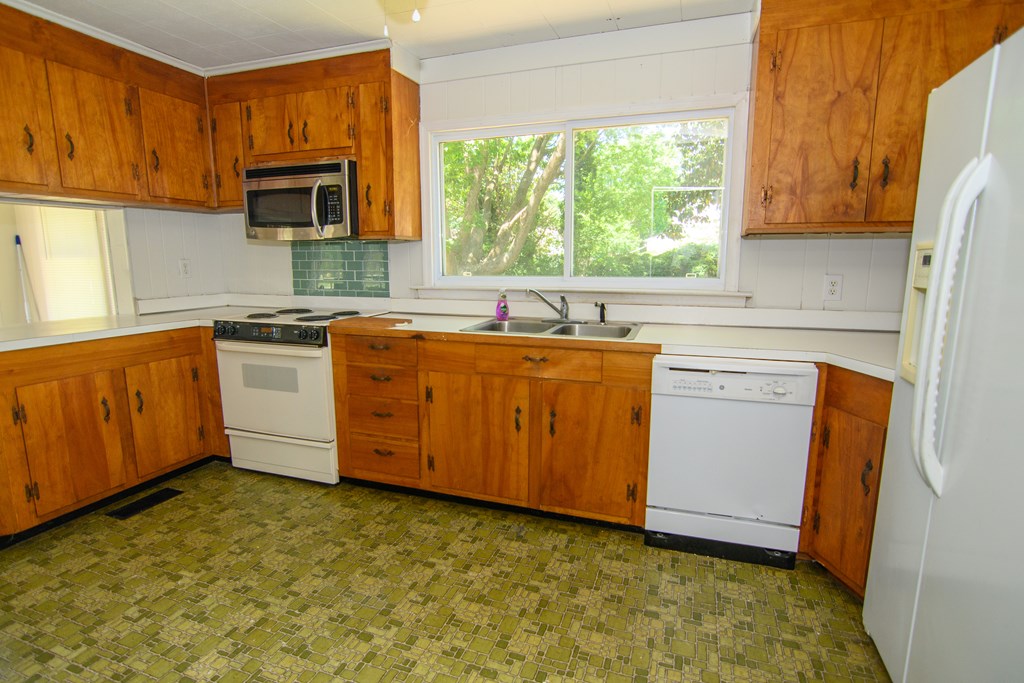 24432 Maxwell Street Parksley, VA 23421 - Photo 9 of 39 a kitchen with a sink stove and cabinets