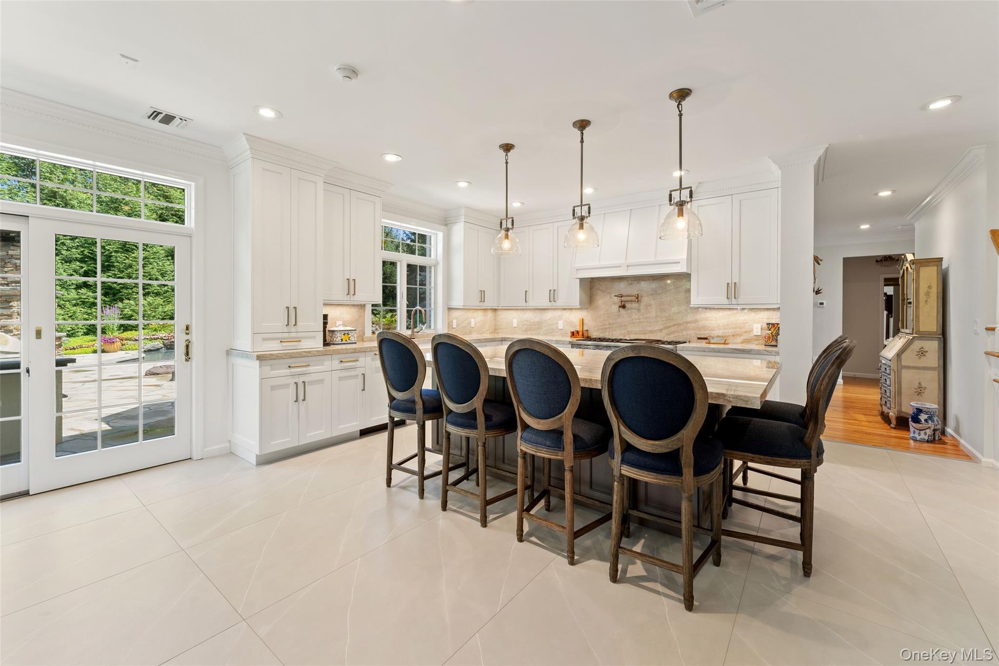 22 Perrin's Peak Road Stony Point, NY 10980 - Photo 31 of 47 Kitchen with ornamental molding, light tile patterned flooring, white cabinetry, decorative backsplash, and a center island