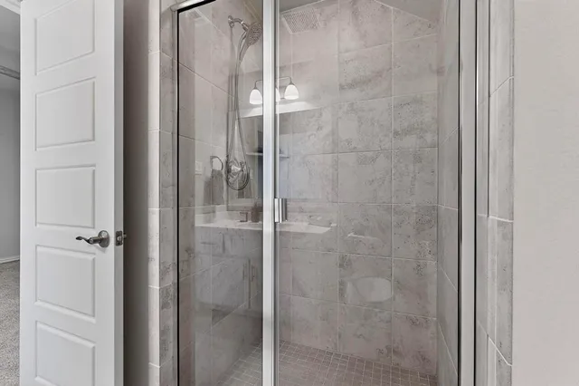 an empty room with a ceiling fan and a window