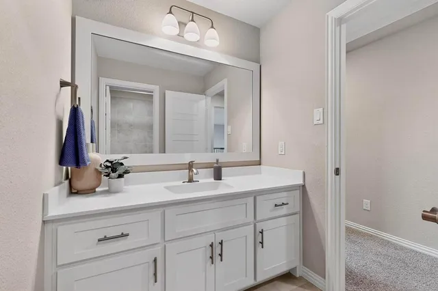 a bathroom with a glass shower door