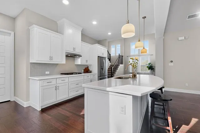 a kitchen with a sink stainless steel appliances and cabinets