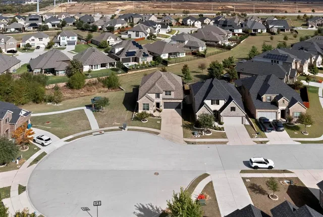 an aerial view of a house with yard and furniture